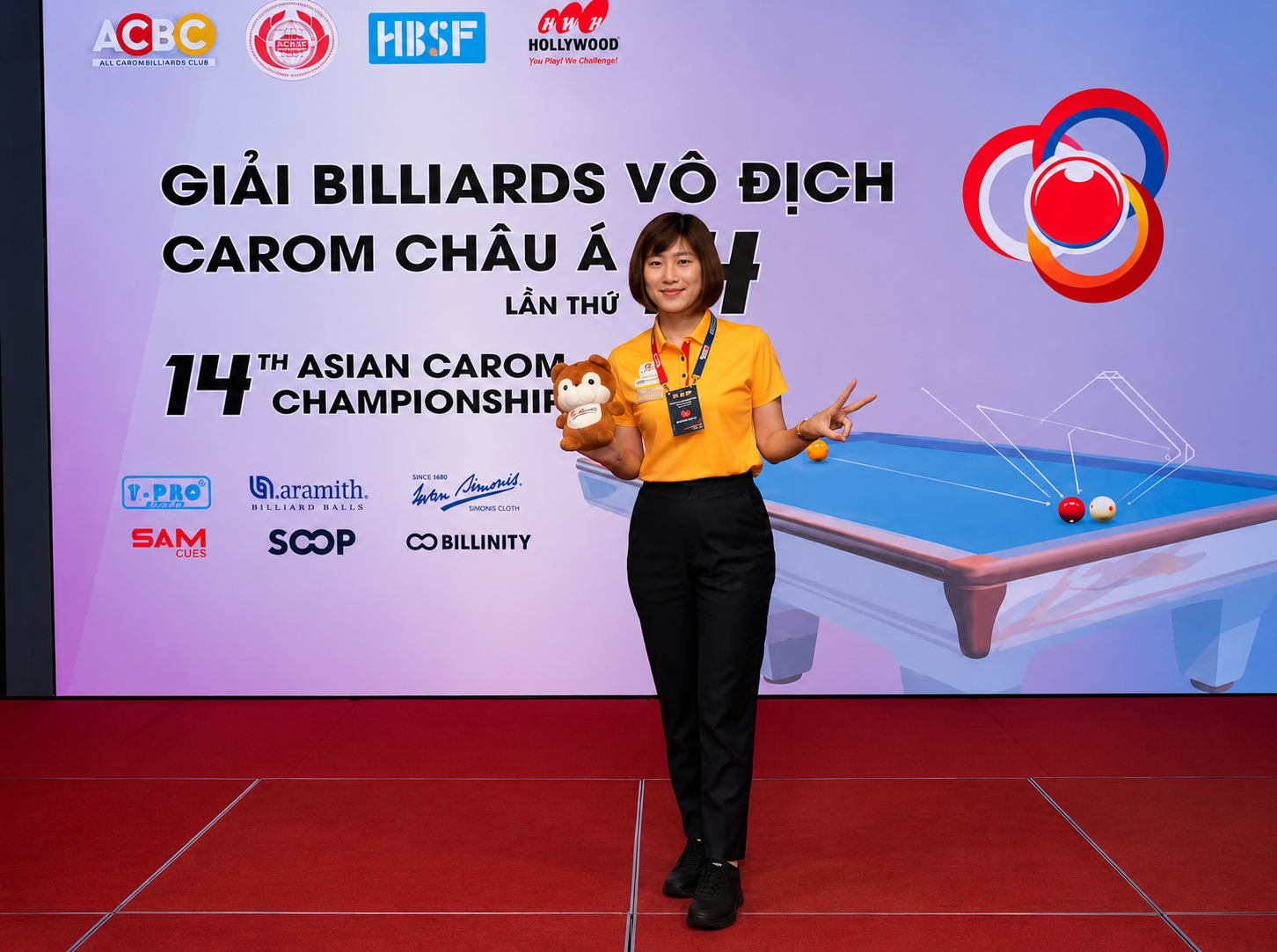 Vận động viên billiards vào thế đánh trên bàn carom